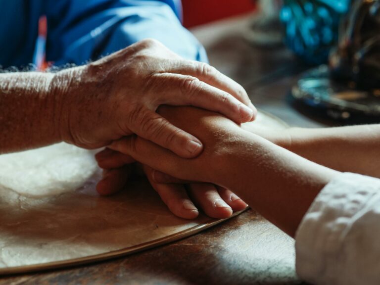 Close-up of supportive hands showing love and care. Ideal for themes of empathy and bonding.